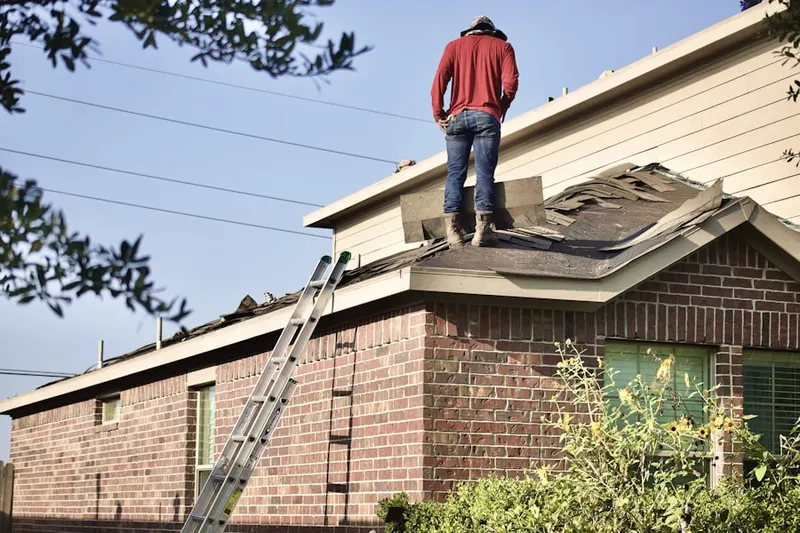 Professional roofer working on a residential roof in Westview